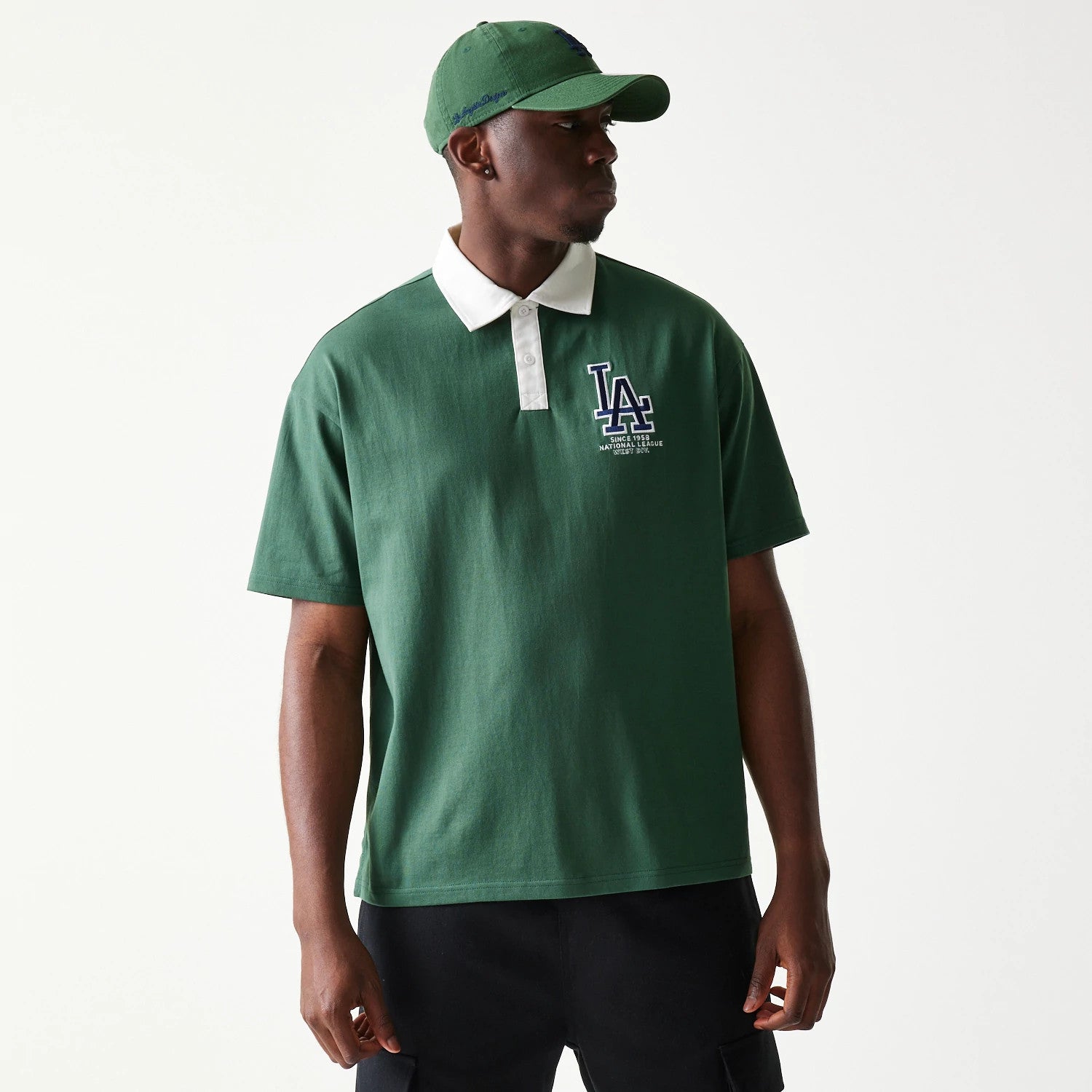The model is wearing this MLB LA Dodgers Oversized Polo T-Shirt in dark green. 1