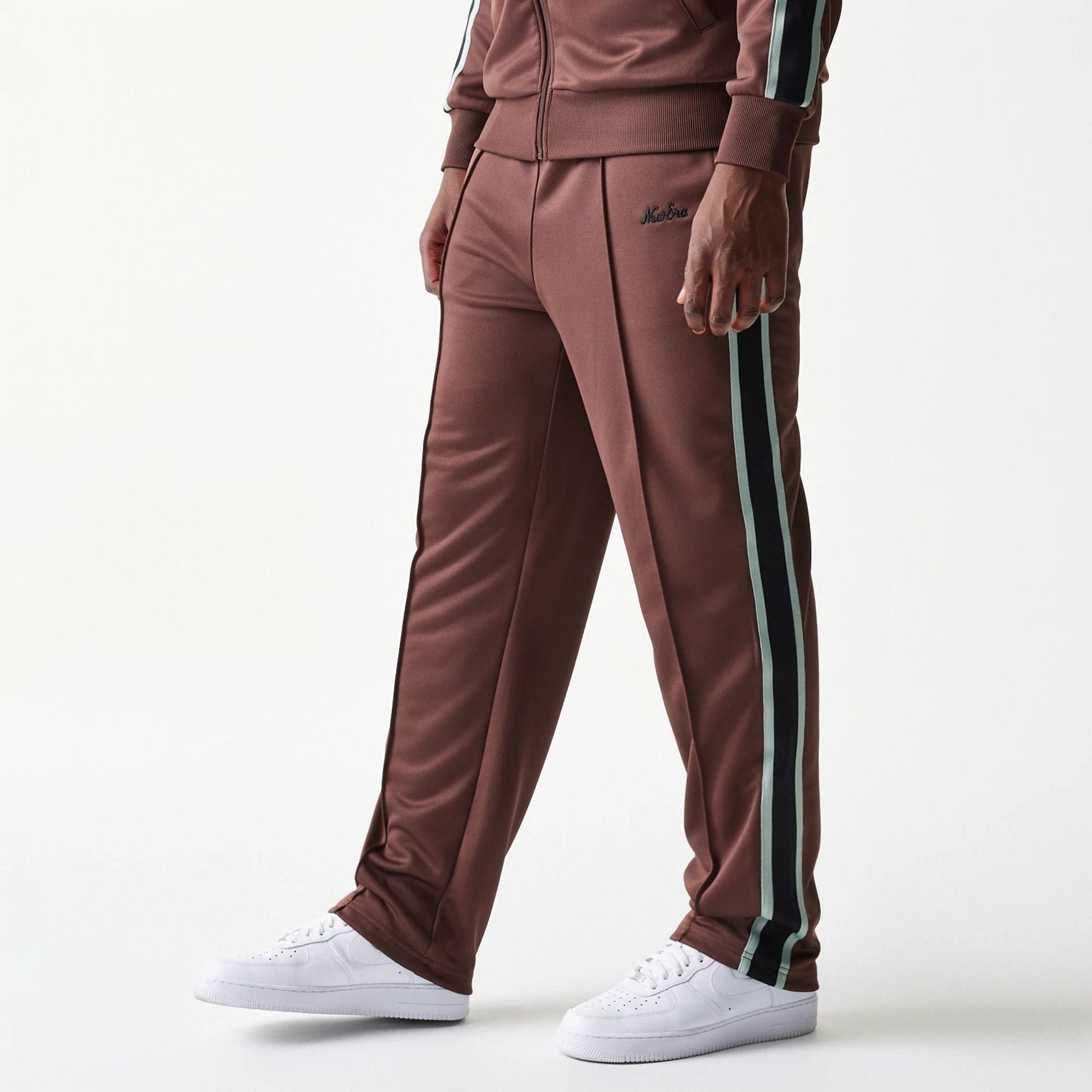 The model is wearing this New Era Script Straight Leg Joggers in brown. 1