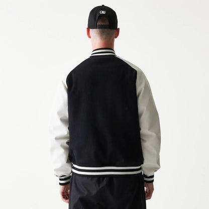 The model is wearing this MLB New York Yankees Varsity Jacket in black. 2