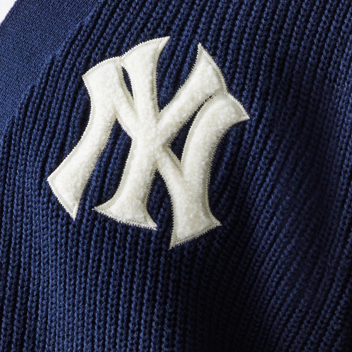 The model is wearing this MLB Collegiate New York Yankees Cardigan in navy. 6