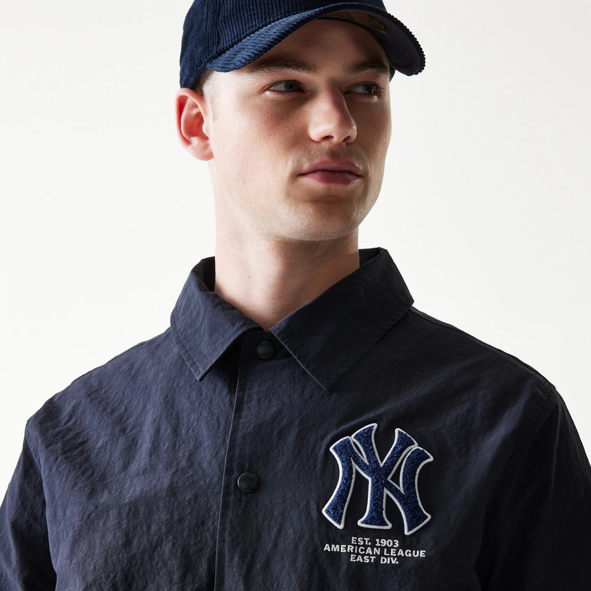 The model is wearing this MLB Coaches New York Yankees Jacket in navy. 5