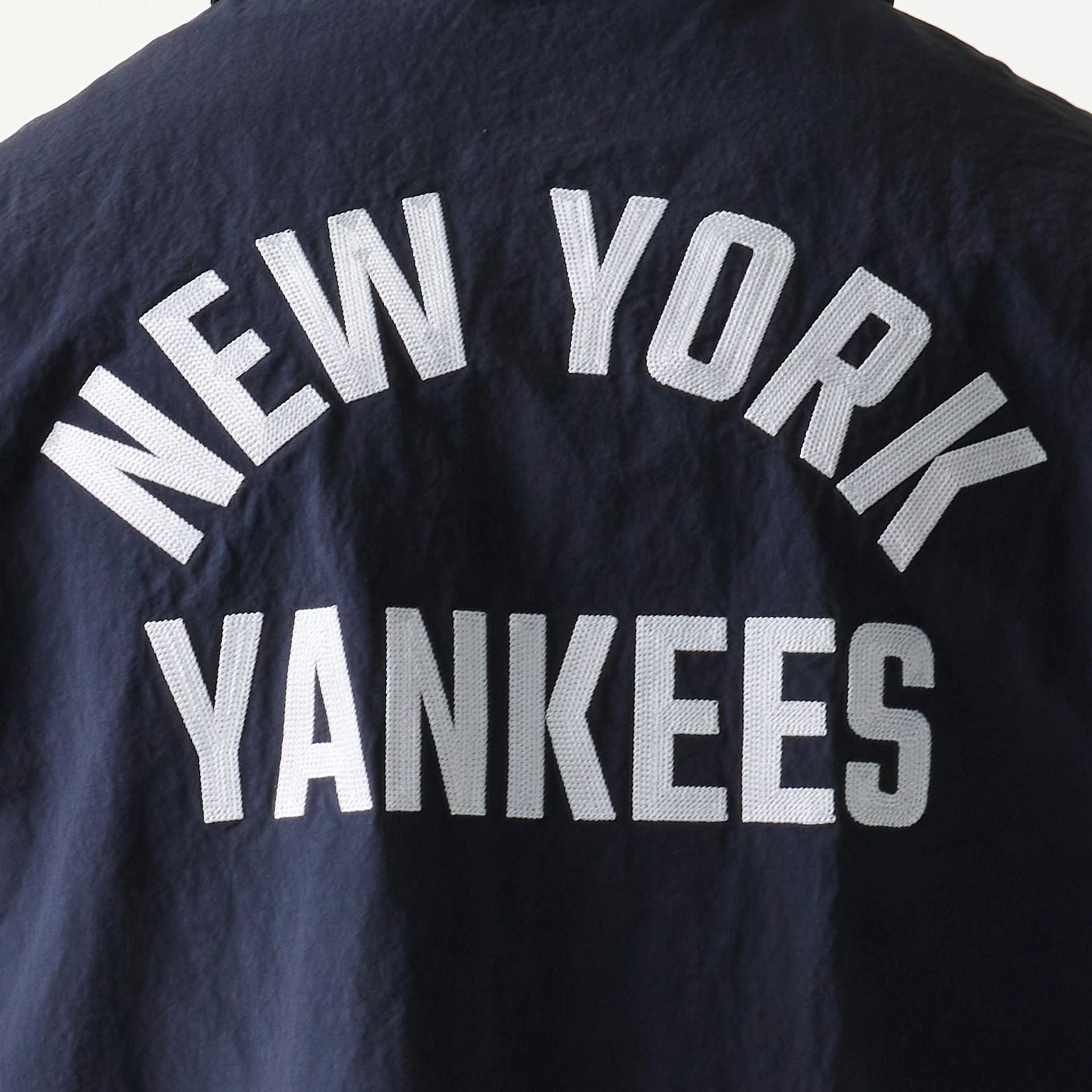 The model is wearing this MLB Coaches New York Yankees Jacket in navy. 6