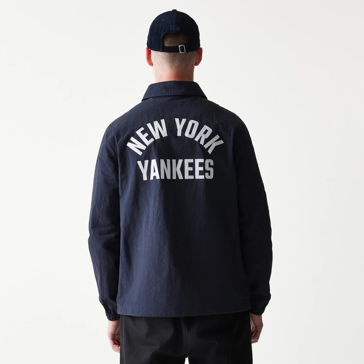 The model is wearing this MLB Coaches New York Yankees Jacket in navy. 2