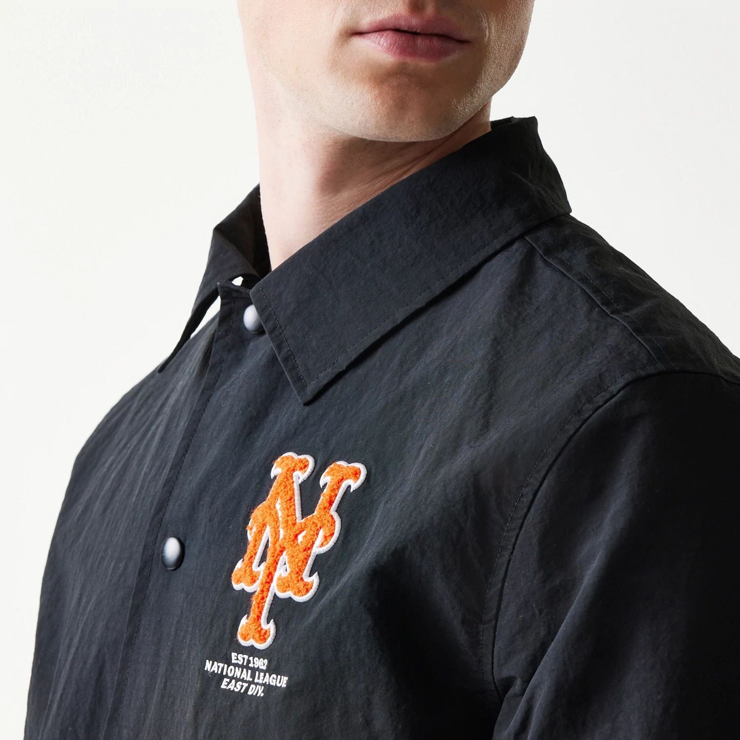 The model is wearing this MLB Coaches New York Mets Jacket in black. 6