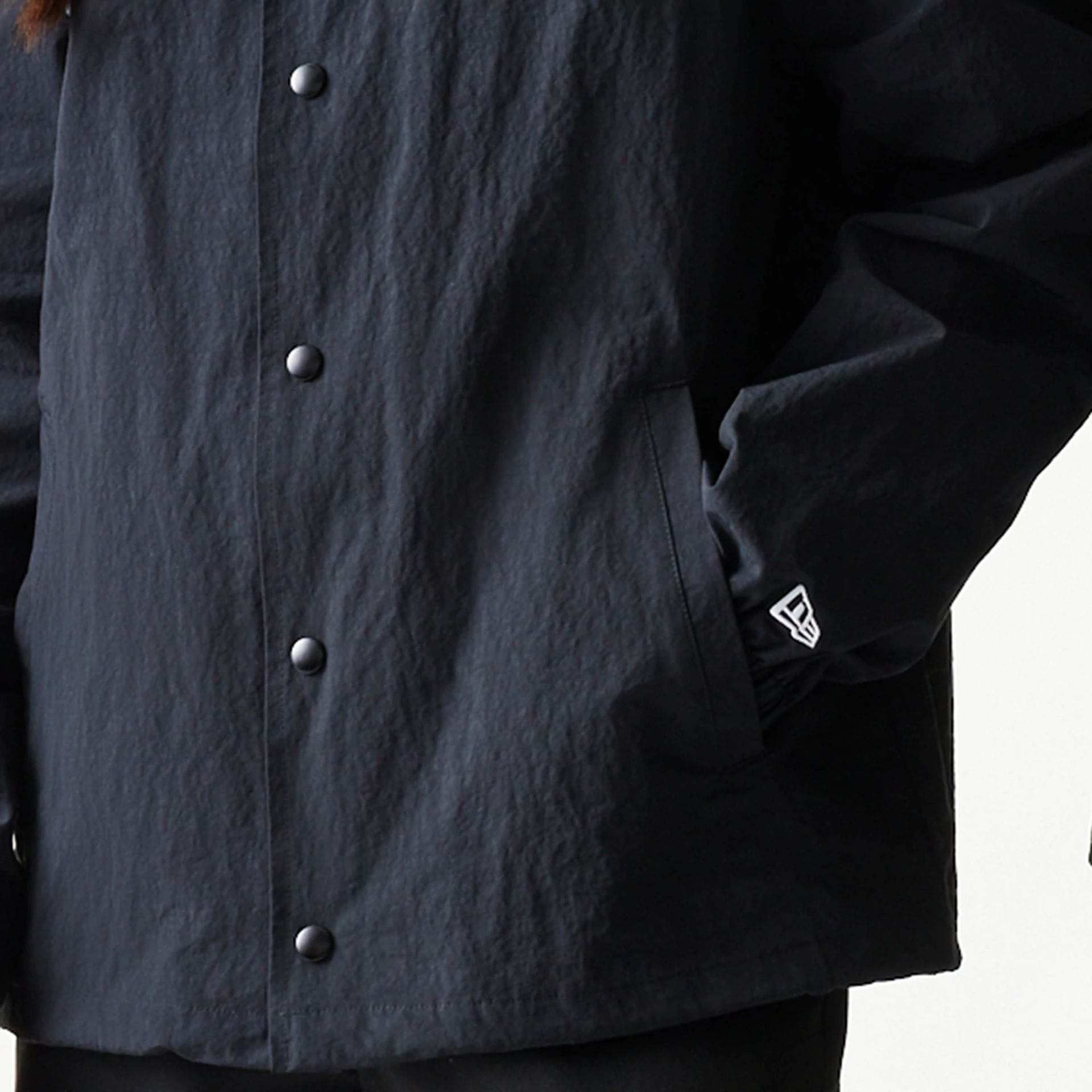 The model is wearing this MLB Coaches New York Mets Jacket in black. 7