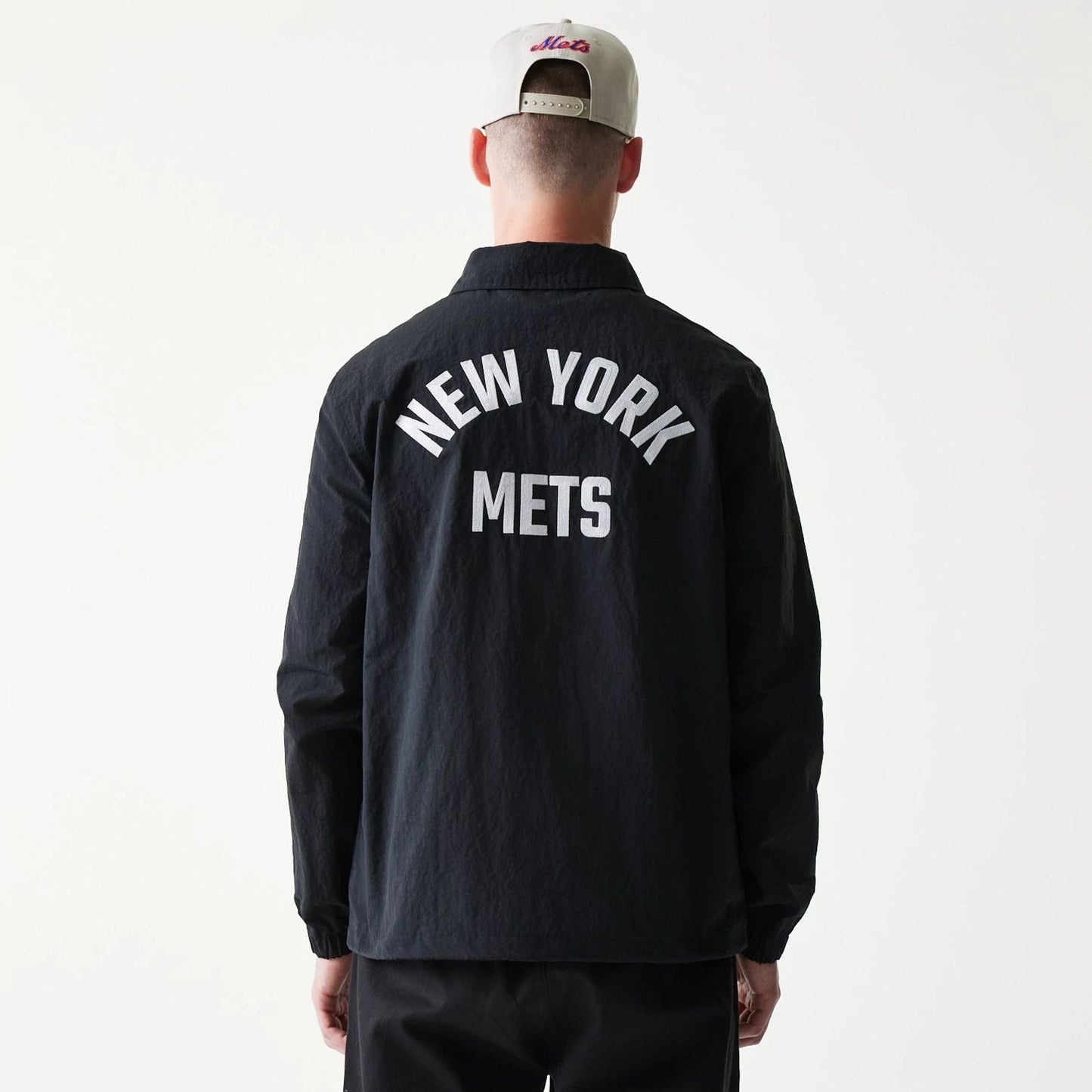 The model is wearing this MLB Coaches New York Mets Jacket in black. 2