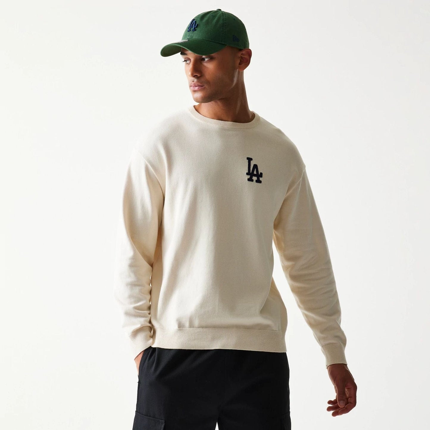 The model is wearing this MLB Essential LA Dodgers Knitted Sweater in open white. 3