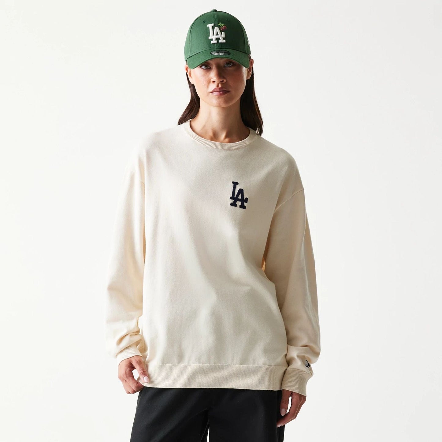 The model is wearing this MLB Essential LA Dodgers Knitted Sweater in open white. 4