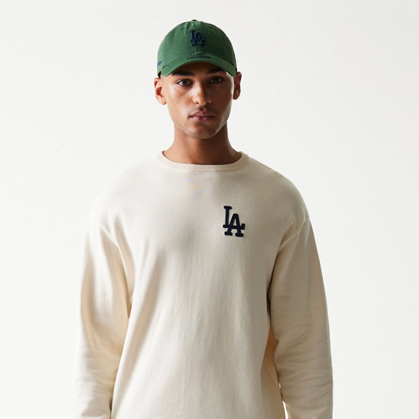 The model is wearing this MLB Essential LA Dodgers Knitted Sweater in open white. 5