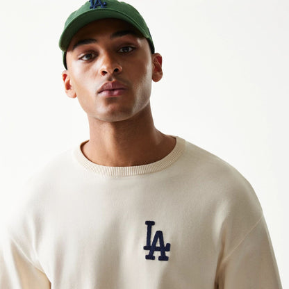 The model is wearing this MLB Essential LA Dodgers Knitted Sweater in open white. 6
