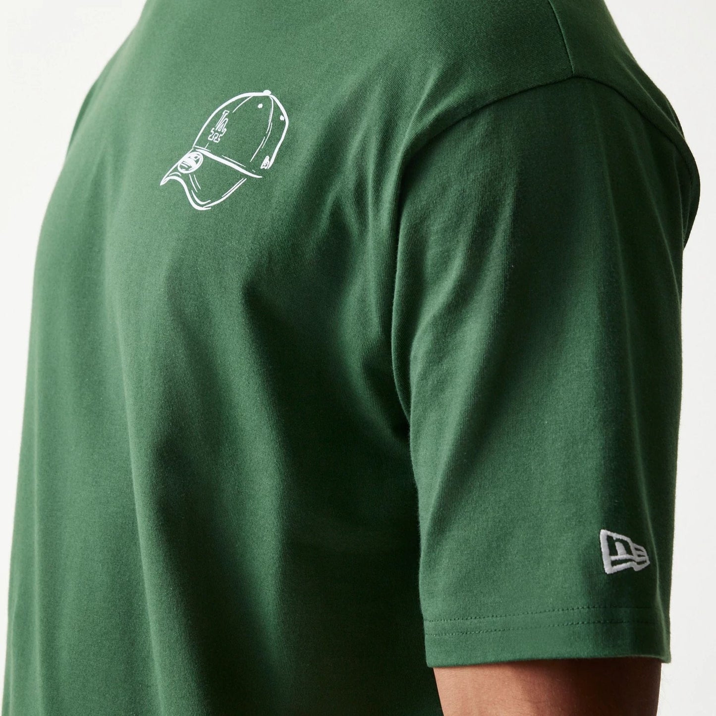 The model is wearing this MLB Baseball Graphic LA Dodgers Oversized T-Shirt in dark green. 7