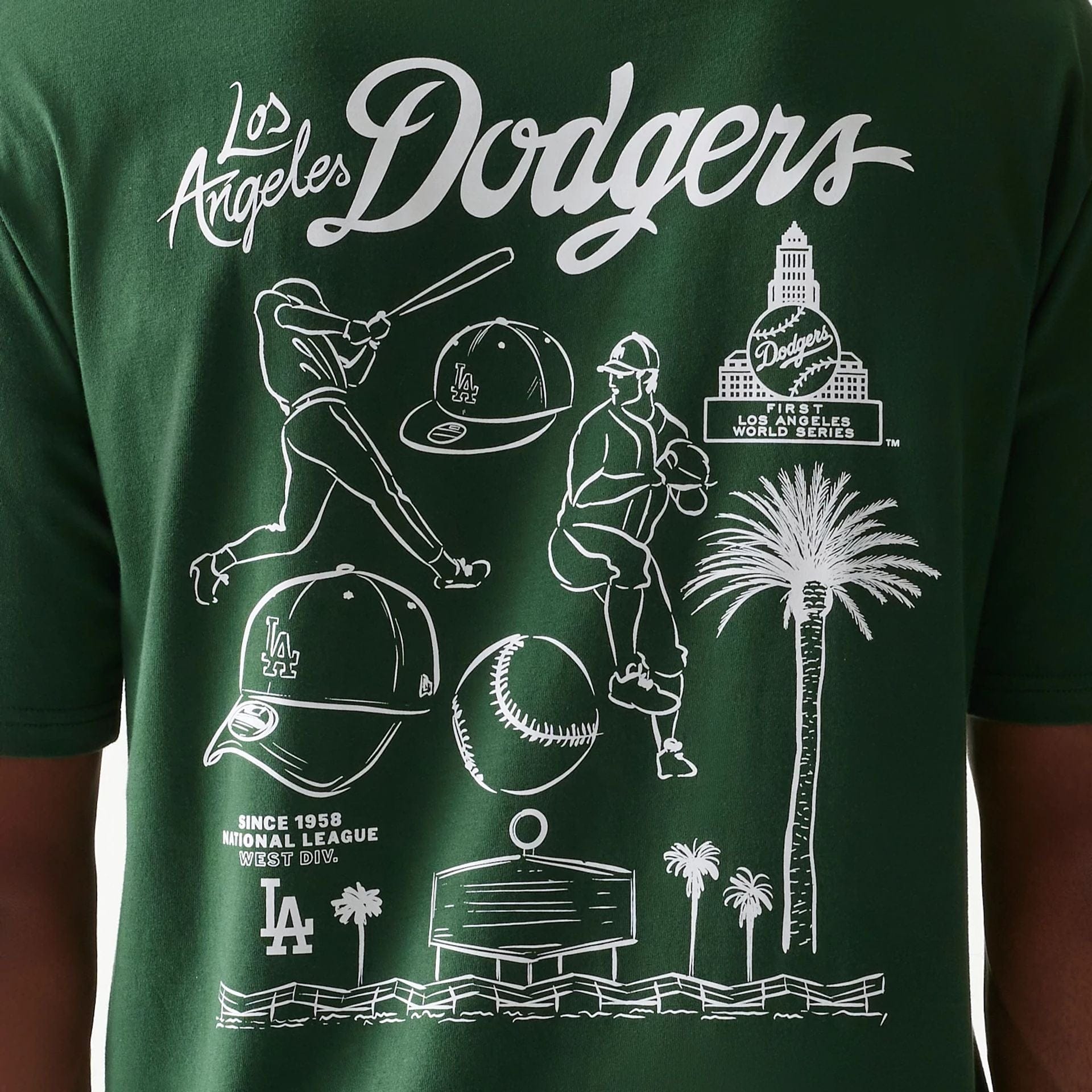 The model is wearing this MLB Baseball Graphic LA Dodgers Oversized T-Shirt in dark green. 8