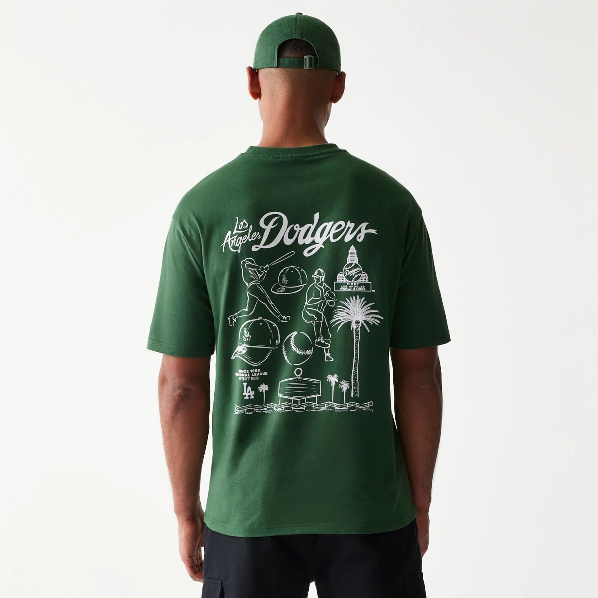 The model is wearing this MLB Baseball Graphic LA Dodgers Oversized T-Shirt in dark green. 2