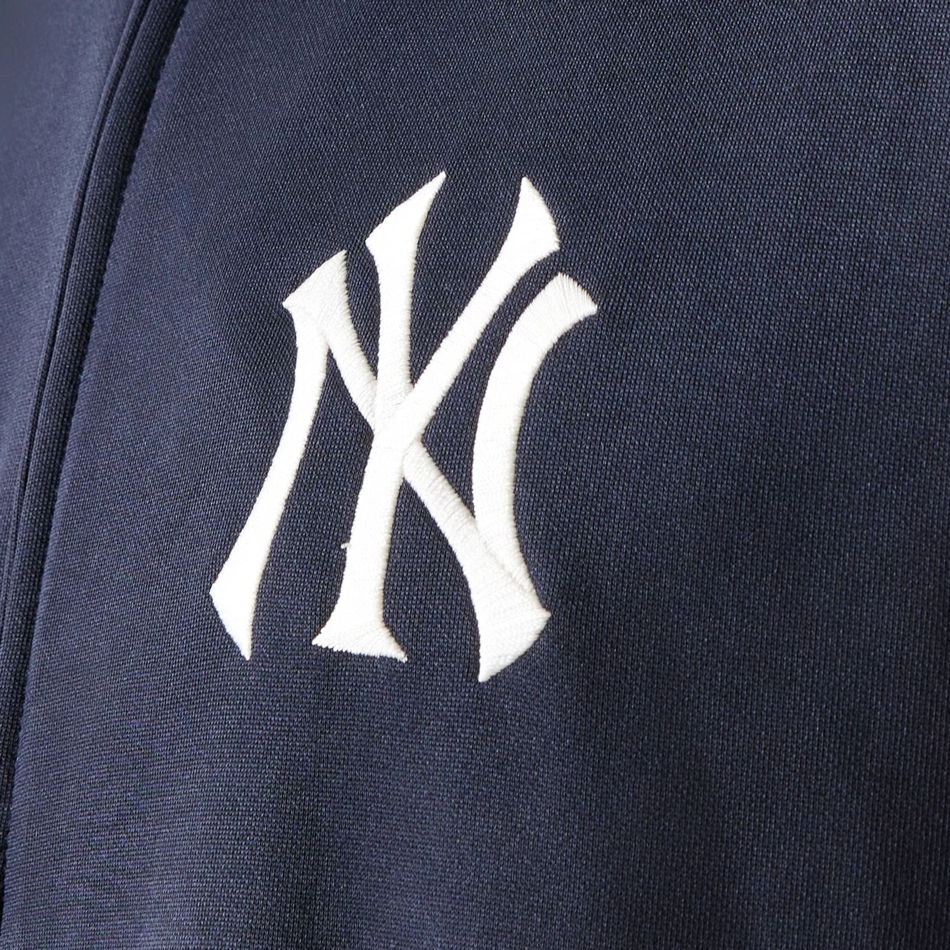 The model is wearing this MLB Piping New York Yankees Track Jacket in navy. 7