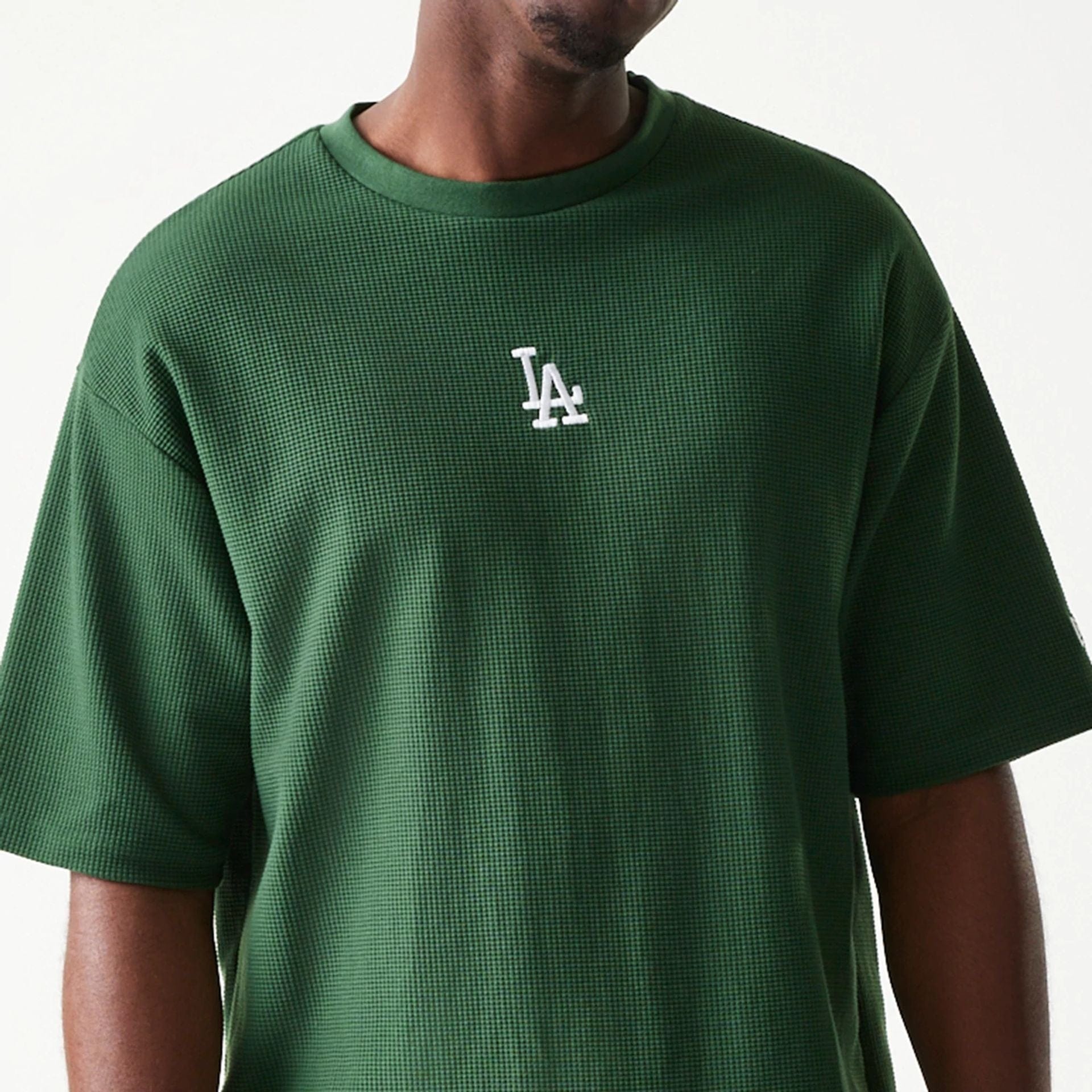The model is wearing this MLB Waffle LA Dodgers Oversized T-Shirt in dark green. 4