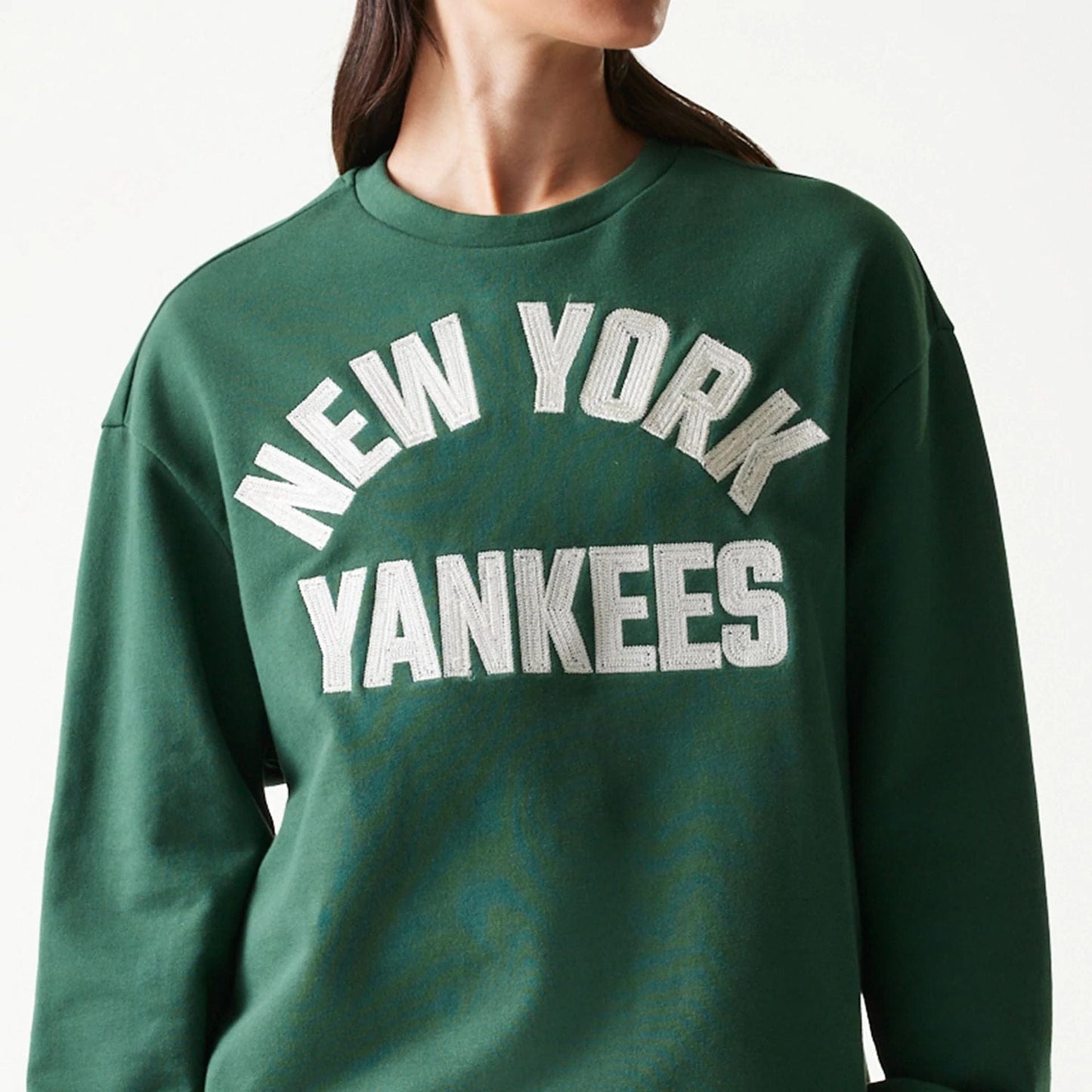 The model is wearing this MLB Graphic New York Yankees Oversized Crew Neck Sweater in dark green. 5