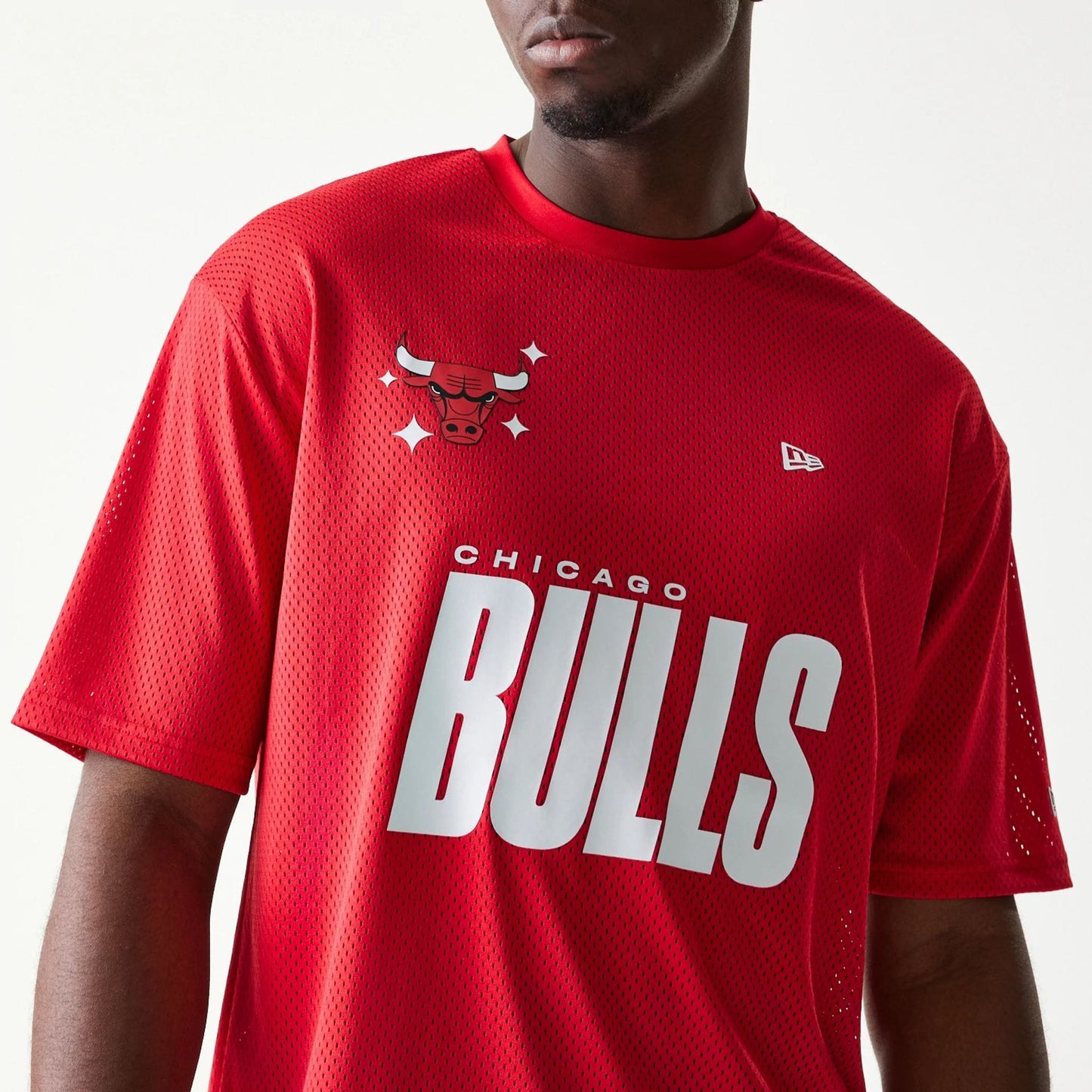 The model is wearing this NBA Graphic Mesh Chicago Bulls T-Shirt in red.  4