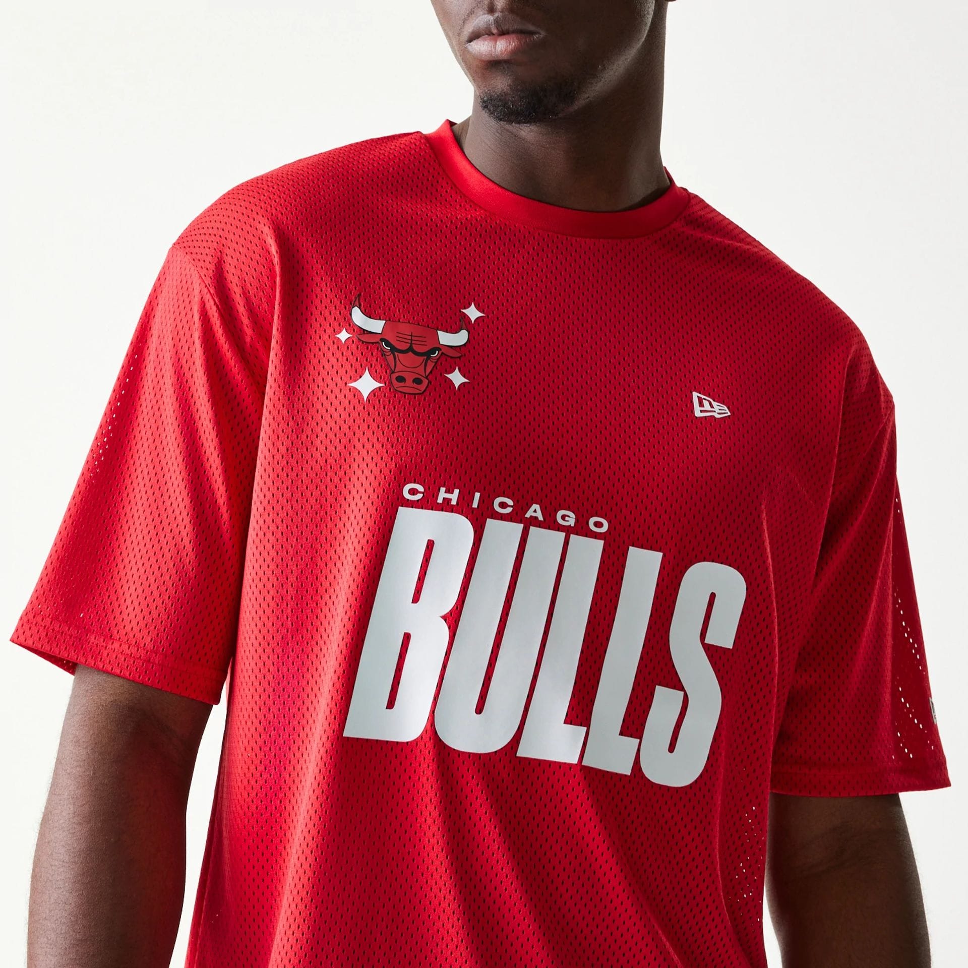 The model is wearing this NBA Graphic Mesh Chicago Bulls T-Shirt in red.  4
