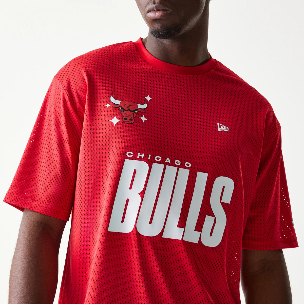 The model is wearing this NBA Graphic Mesh Chicago Bulls T-Shirt in red. 4