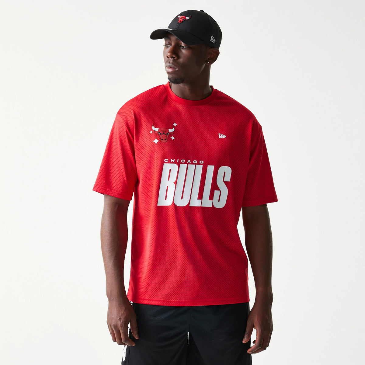 New Era Chicago Bulls NBA Graphic Mesh Red T-Shirt, front view on-model showing a white Bulls text across the chest, the Chicago Bulls logo placed on the left shoulder, and a small embroidered New Era logo on the right chest.