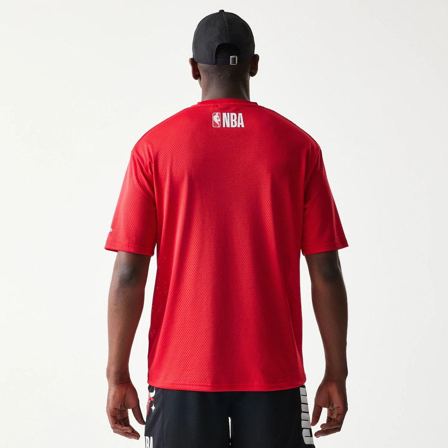 The model is wearing this NBA Graphic Mesh Chicago Bulls T-Shirt in red.  2