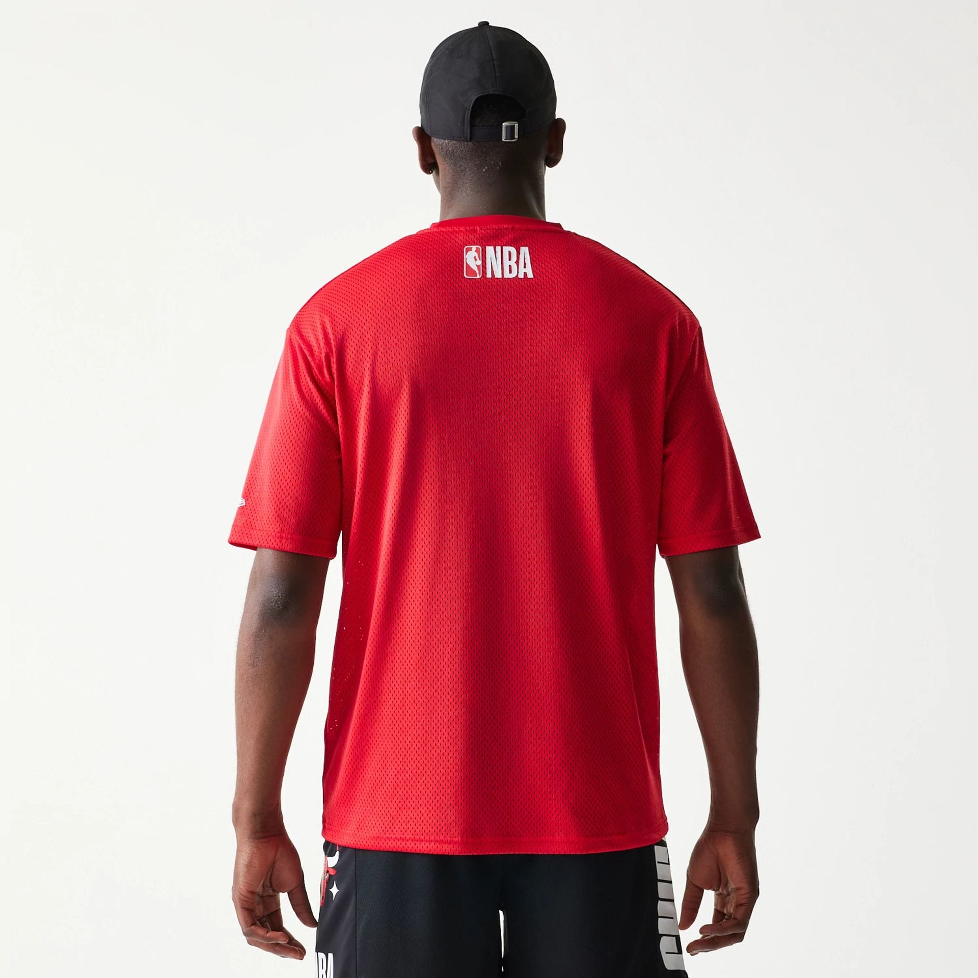 The model is wearing this NBA Graphic Mesh Chicago Bulls T-Shirt in red.  2