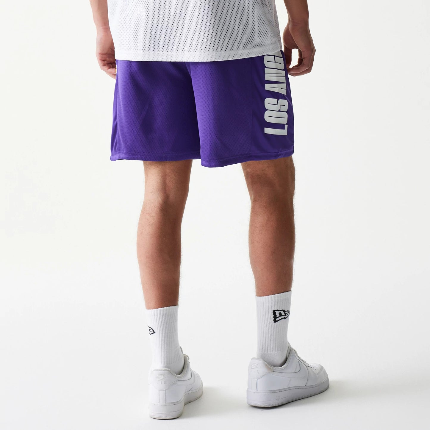 The model is wearing this NBA Mesh LA Lakers Shorts in purple. 2
