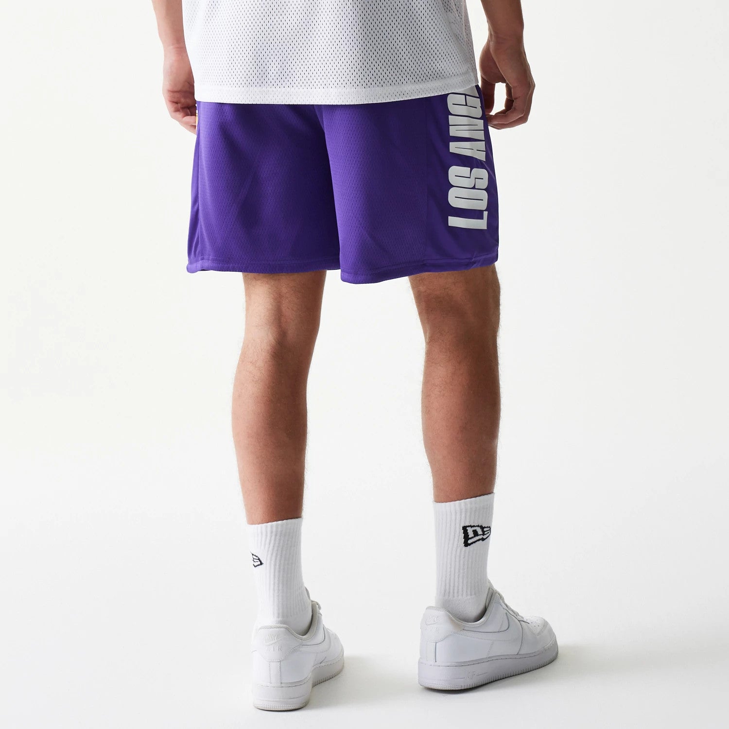 The model is wearing this NBA Mesh LA Lakers Shorts in purple. 2