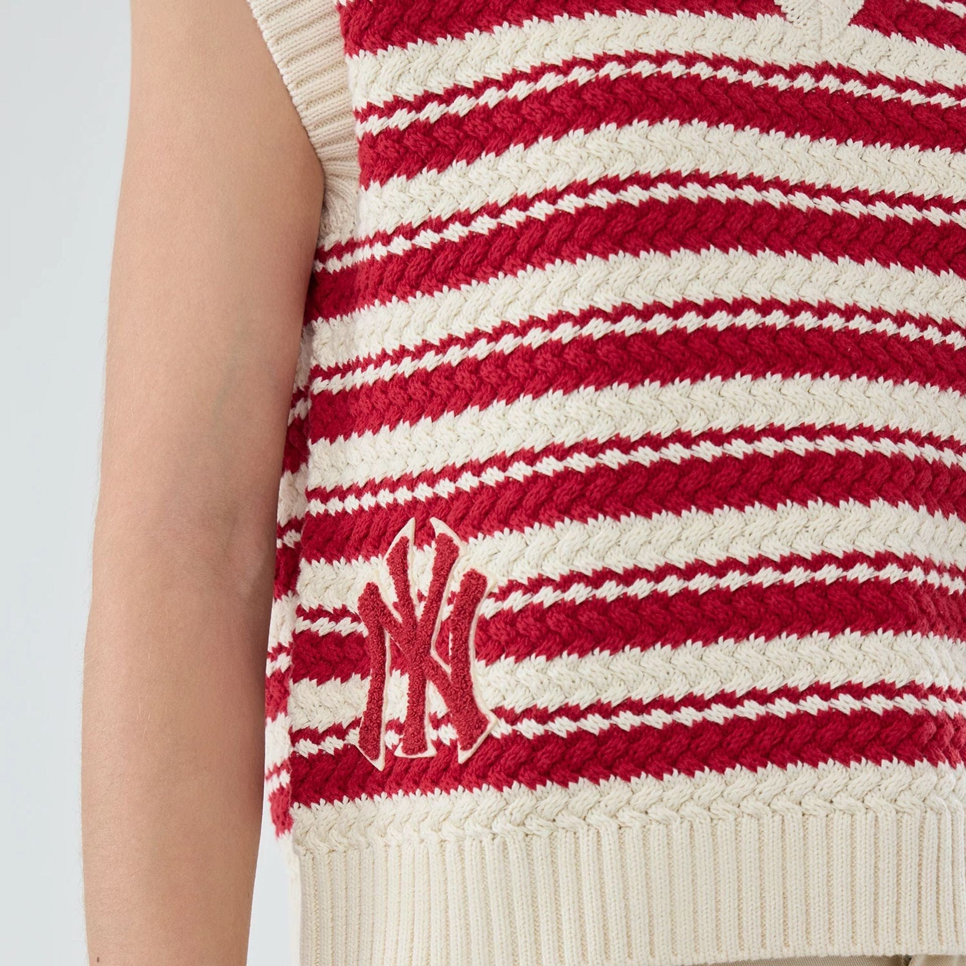 The model is wearing this Womens MLB Knit Stripe New York Yankees Sleeveless  V-neck Sweater in dark red. 3