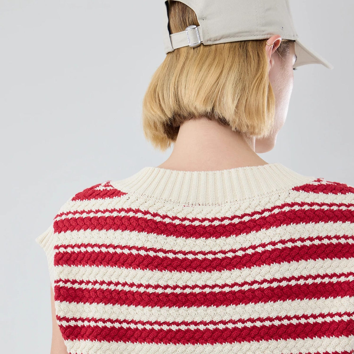 The model is wearing this Womens MLB Knit Stripe New York Yankees Sleeveless  V-neck Sweater in dark red. 7