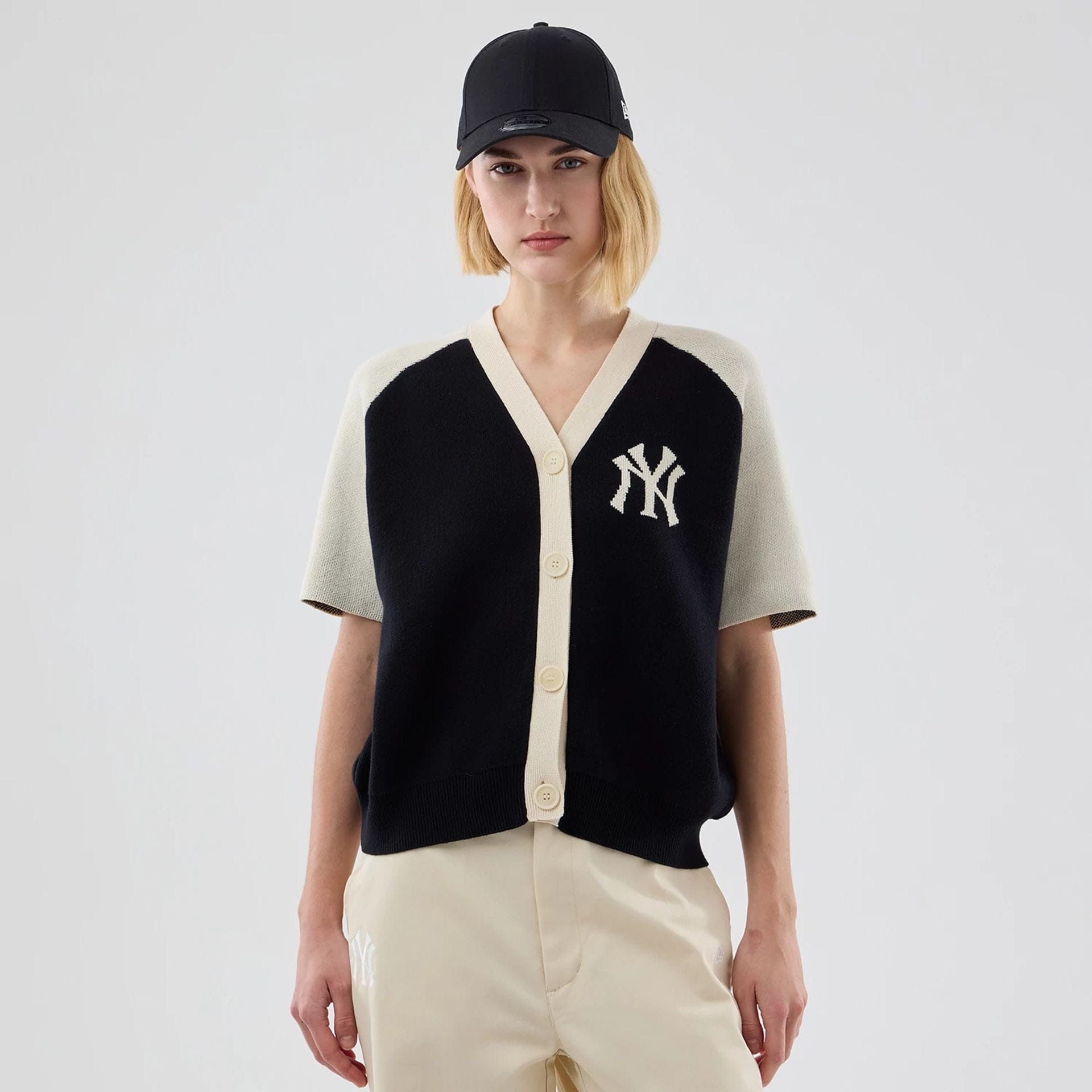 The model is wearing this Womens MLB Knit Stripe New York Yankees Short Sleeve Cardigan in black. 1