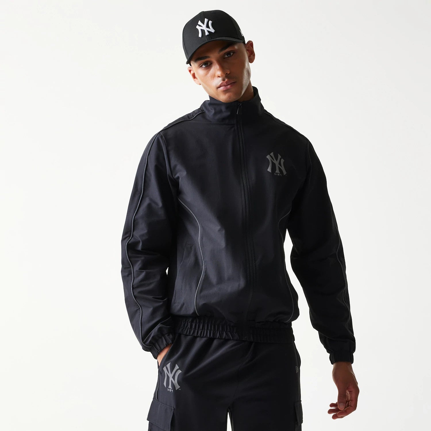 The model is wearing this MLB New York Yankees Track Jacket in black. 3