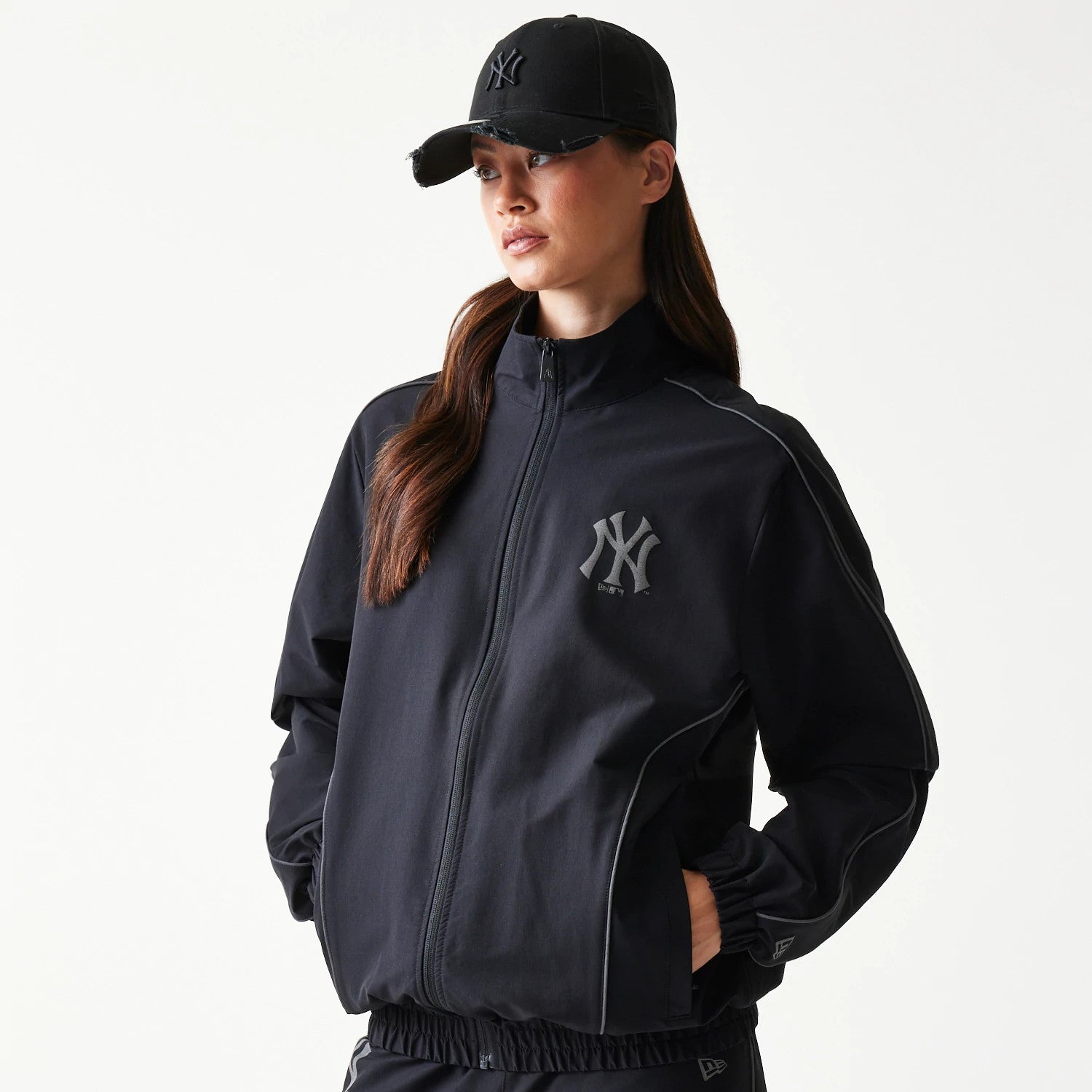 The model is wearing this MLB New York Yankees Track Jacket in black. 4