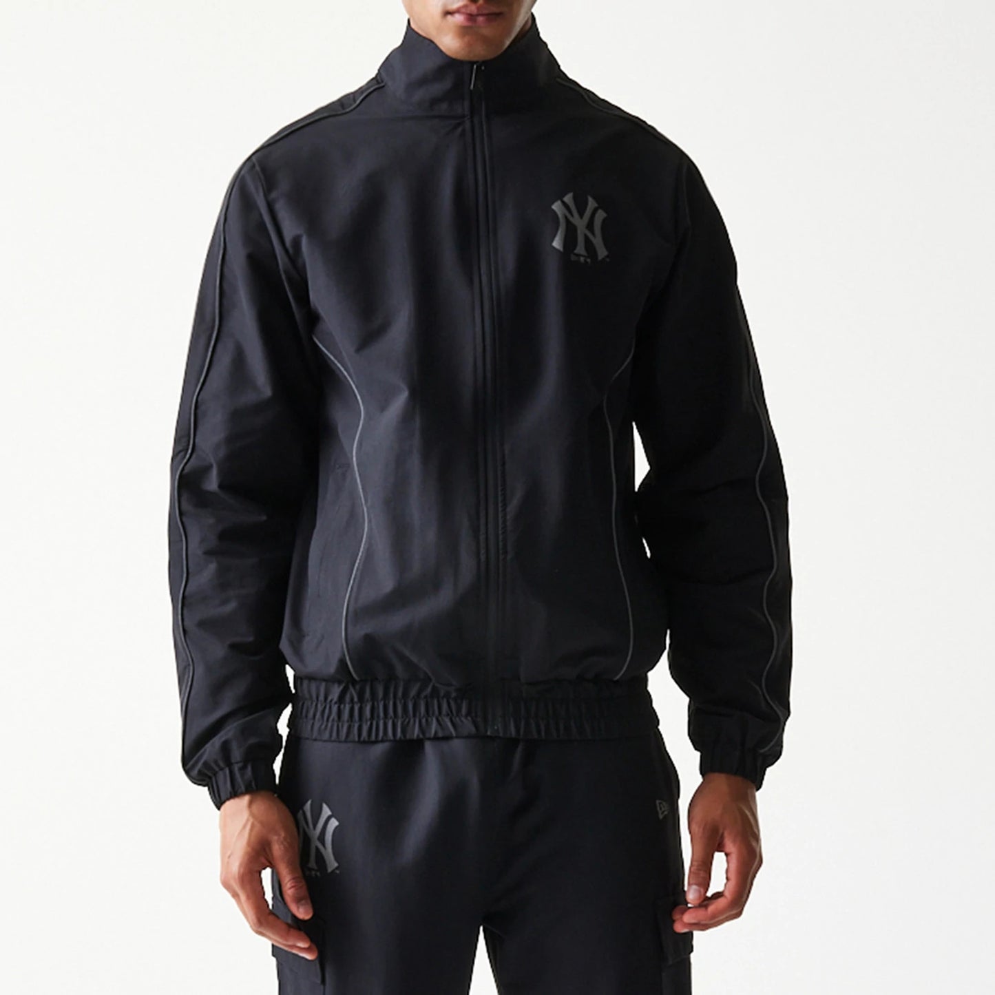 The model is wearing this MLB New York Yankees Track Jacket in black. 5