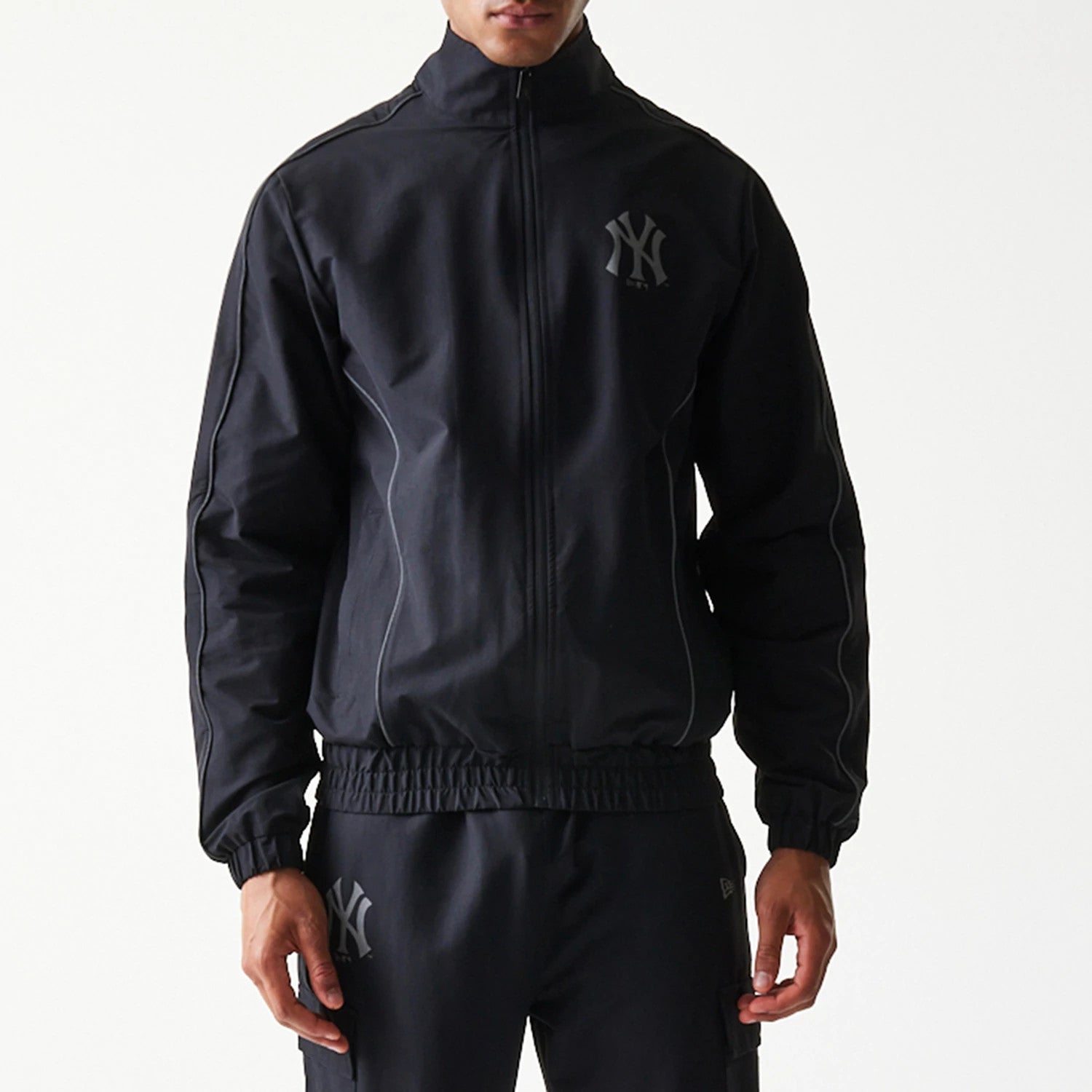 The model is wearing this MLB New York Yankees Track Jacket in black. 5