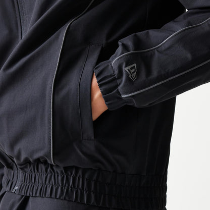 New Era New York Yankees MLB Black Track Jacket, front view showing a close-up of the sleeve with grey piping, an elasticated cuff, a small raised logo near the wrist, and a zipped side pocket against the black fabric.