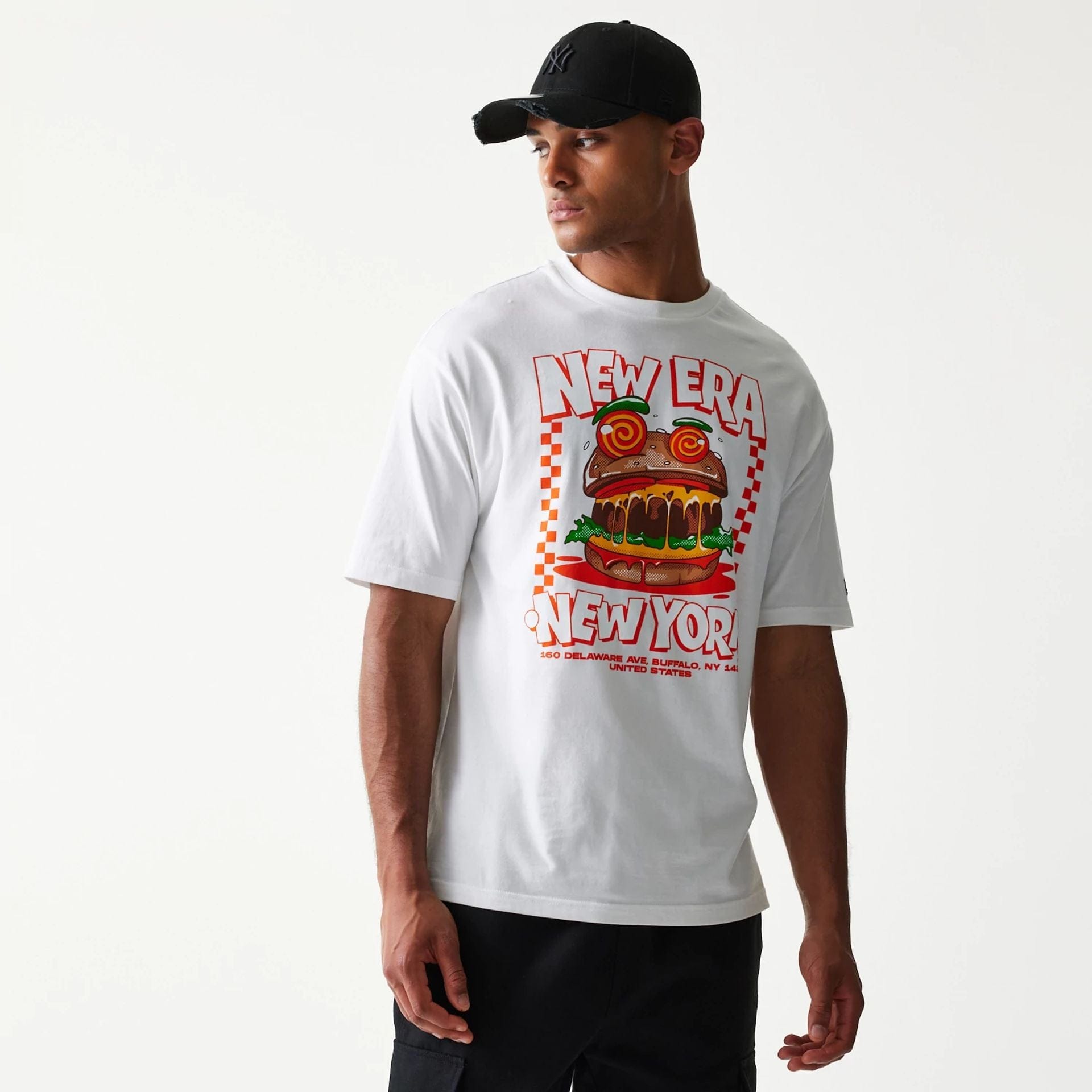 The model is wearing this New Era Burger Food Graphic Oversized T-Shirt in white. 3