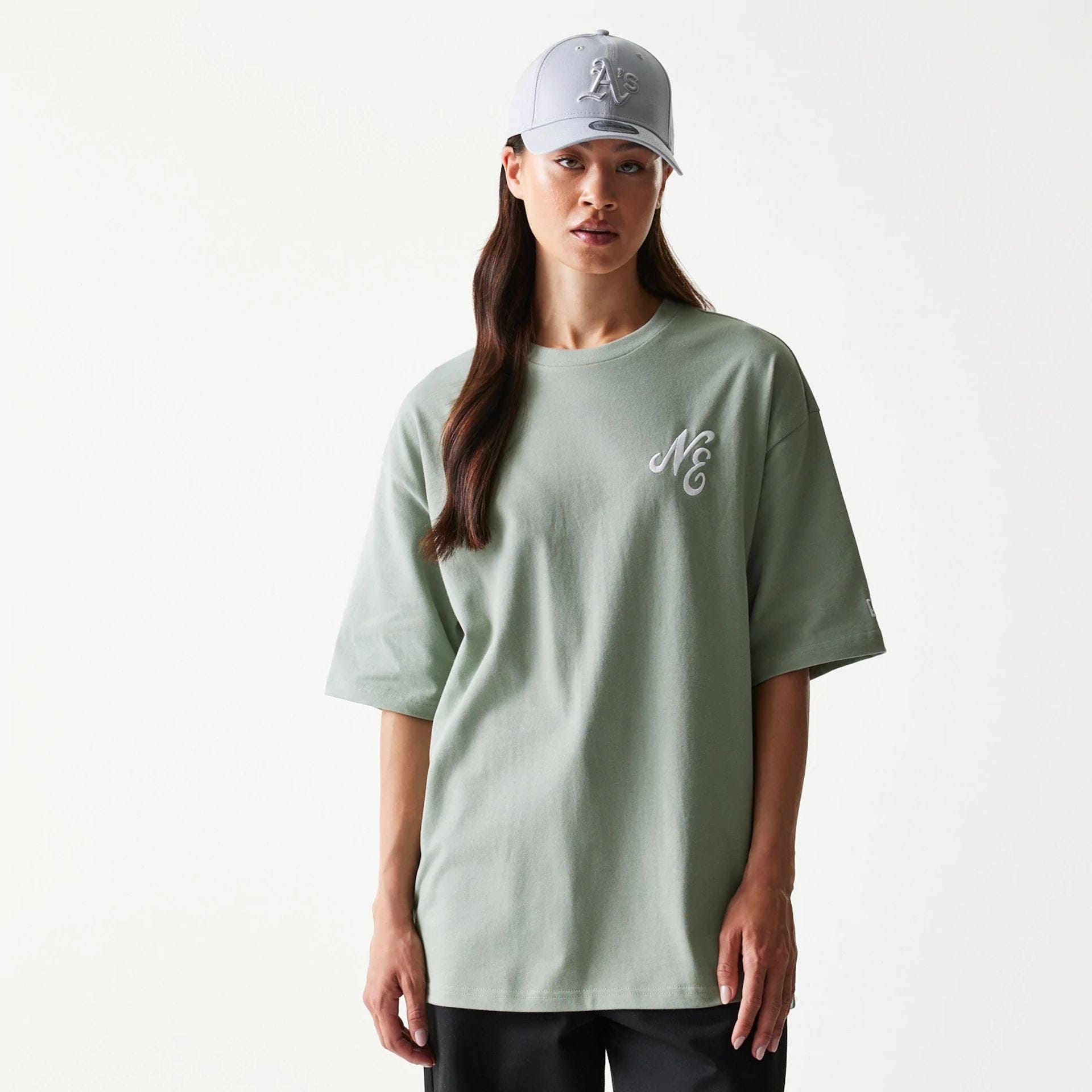 The model is wearing this New Era Floral Graphic Oversized T-Shirt in pastel green. 4
