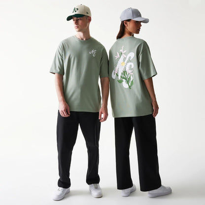 The model is wearing this New Era Floral Graphic Oversized T-Shirt in pastel green. 1