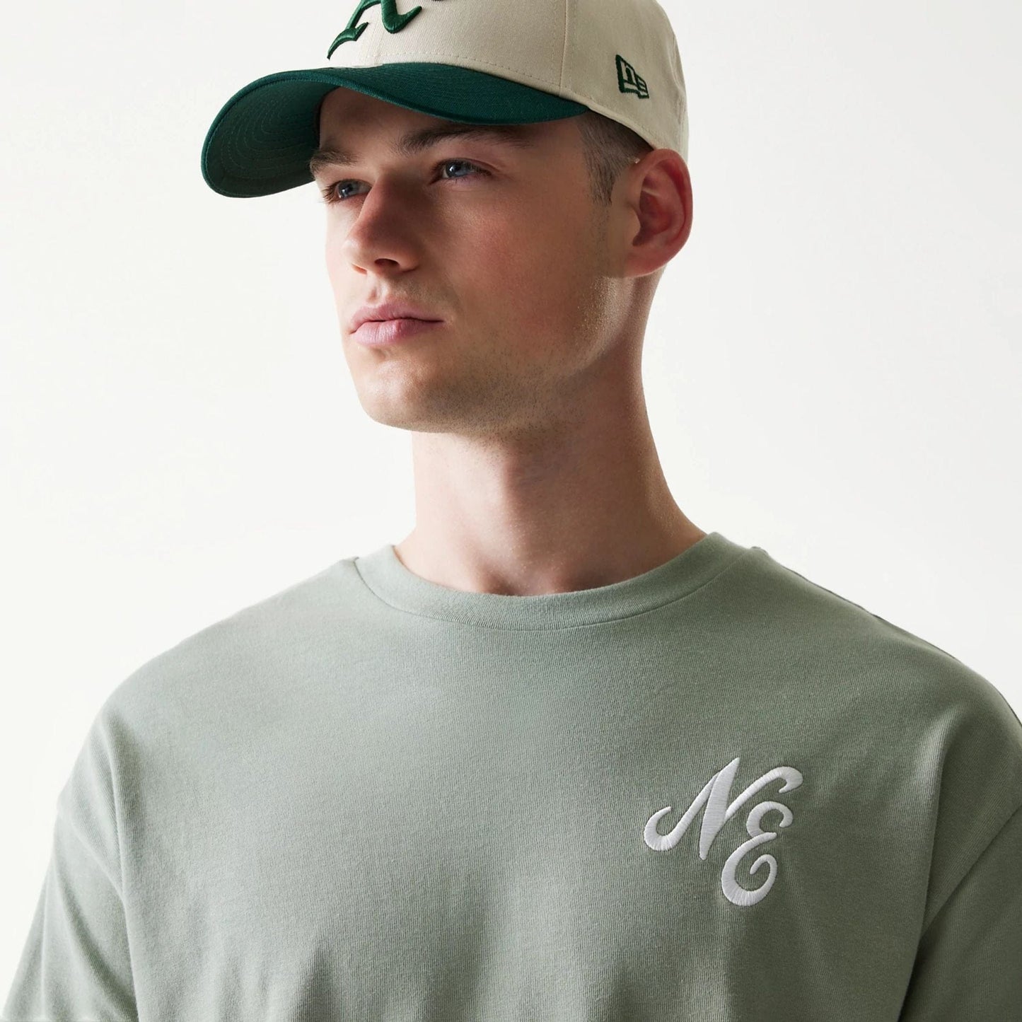The model is wearing this New Era Floral Graphic Oversized T-Shirt in pastel green. 6