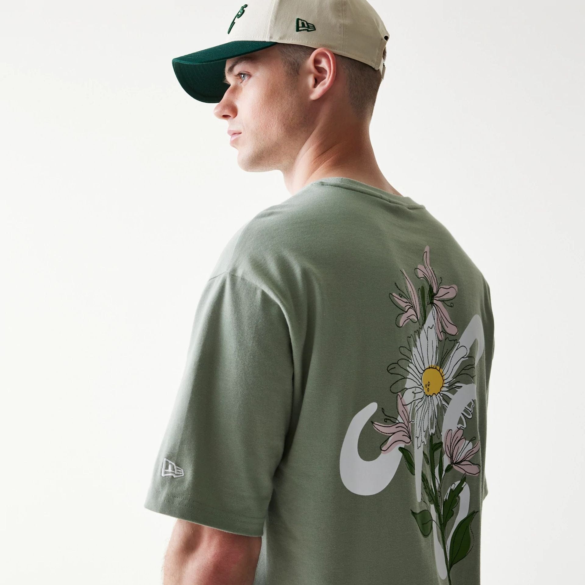 The model is wearing this New Era Floral Graphic Oversized T-Shirt in pastel green. 8