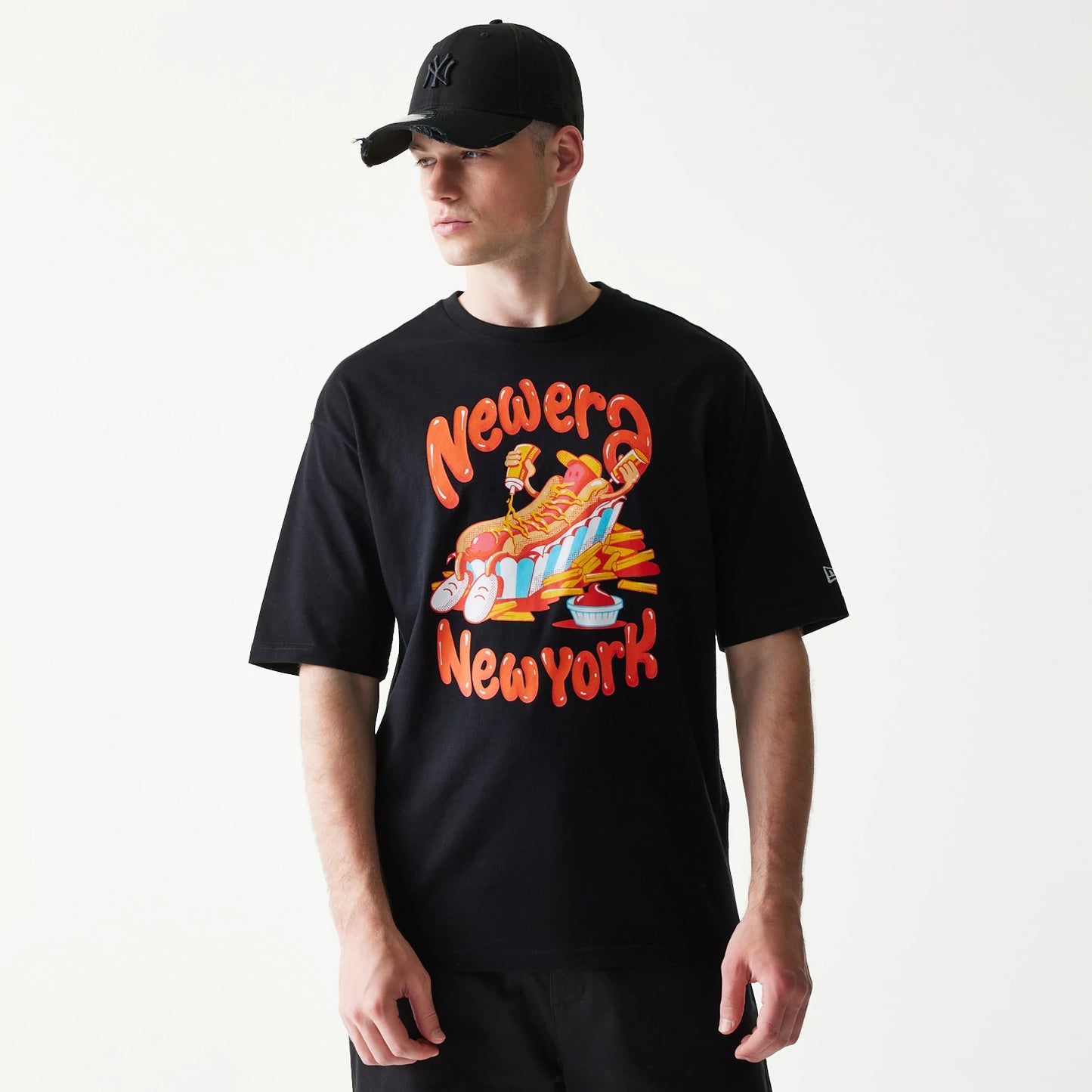 The model is wearing this New Era Hotdog Food Graphic Oversized T-Shirt in black. 3