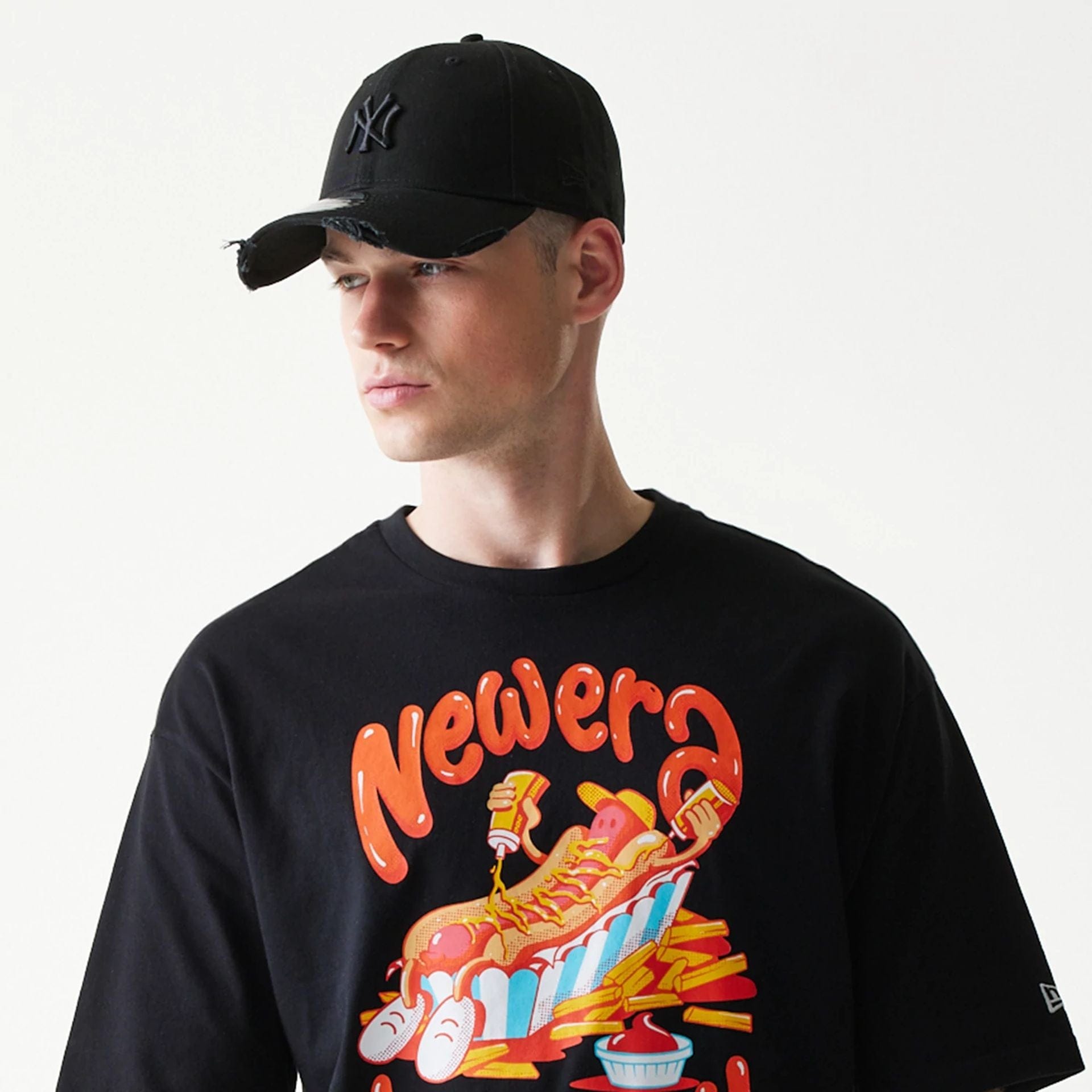 The model is wearing this New Era Hotdog Food Graphic Oversized T-Shirt in black. 5