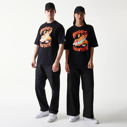 New Era Hotdog Food Graphic Black Oversized T-Shirt, front view on-model showing a graphic of a hotdog with colourful toppings, 'New Era New York' lettering, and an embroidered New Era logo on the sleeve.