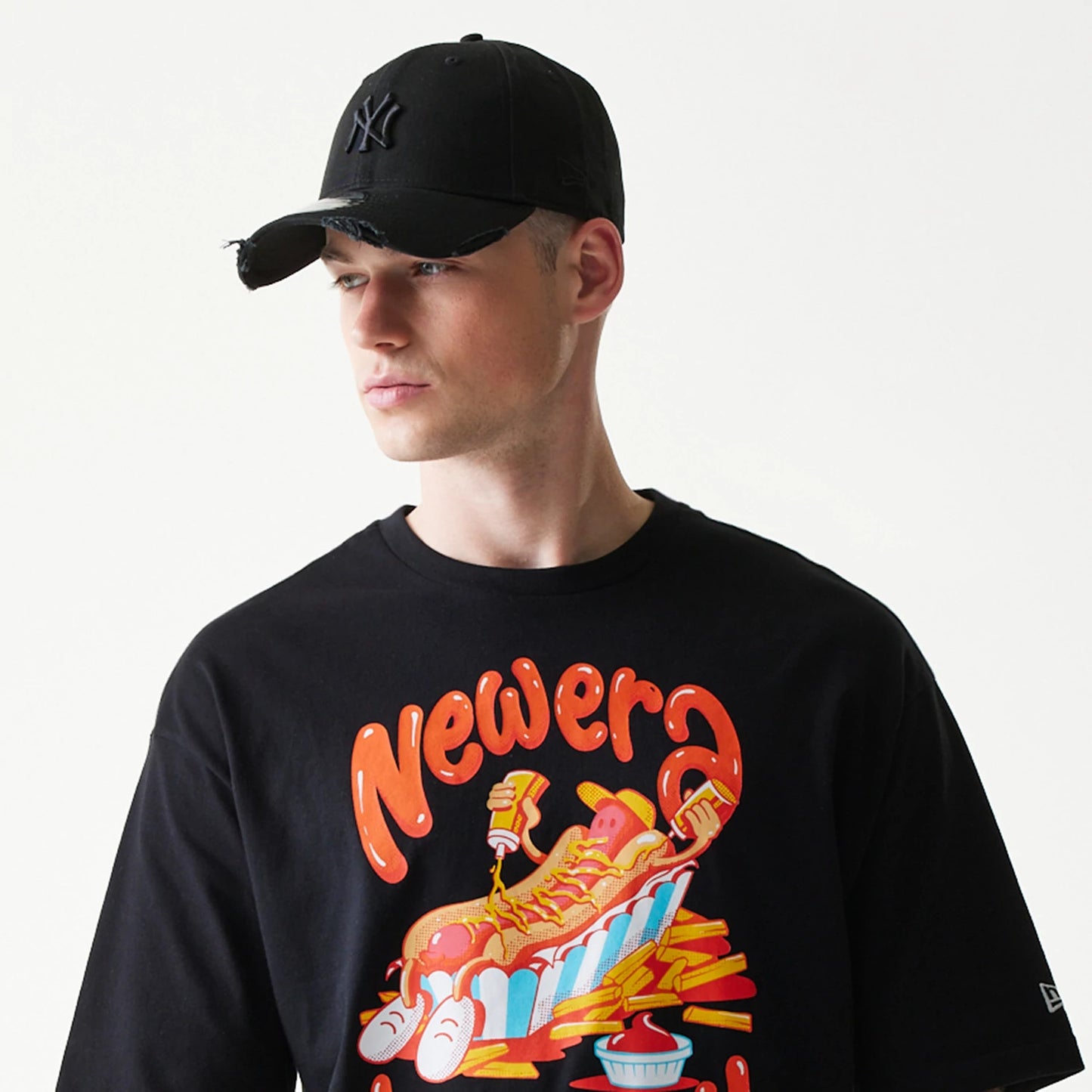 The model is wearing this New Era Hotdog Food Graphic Oversized T-Shirt in black. 5