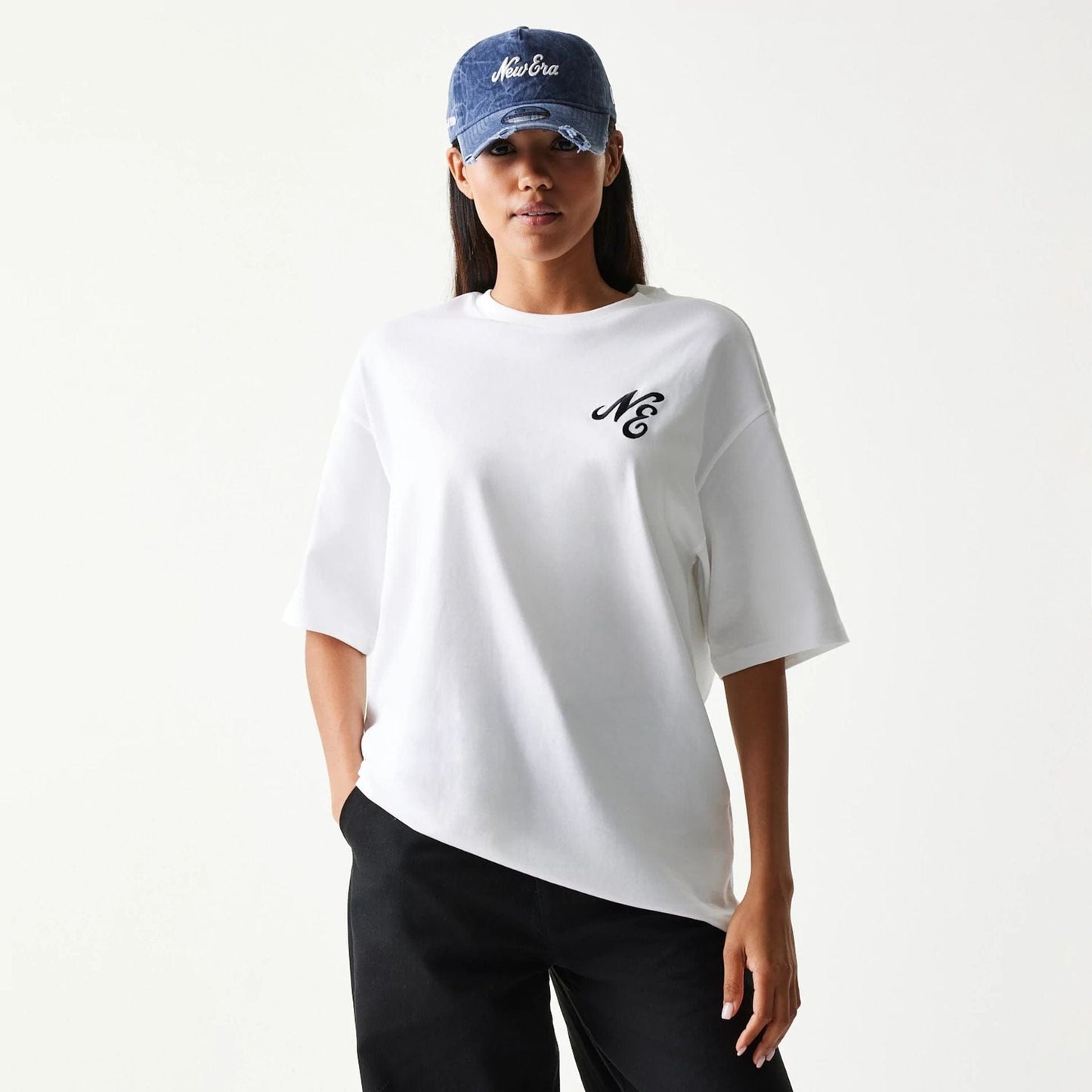 The model is wearing this New Era Floral Graphic Oversized T-Shirt in white. 4