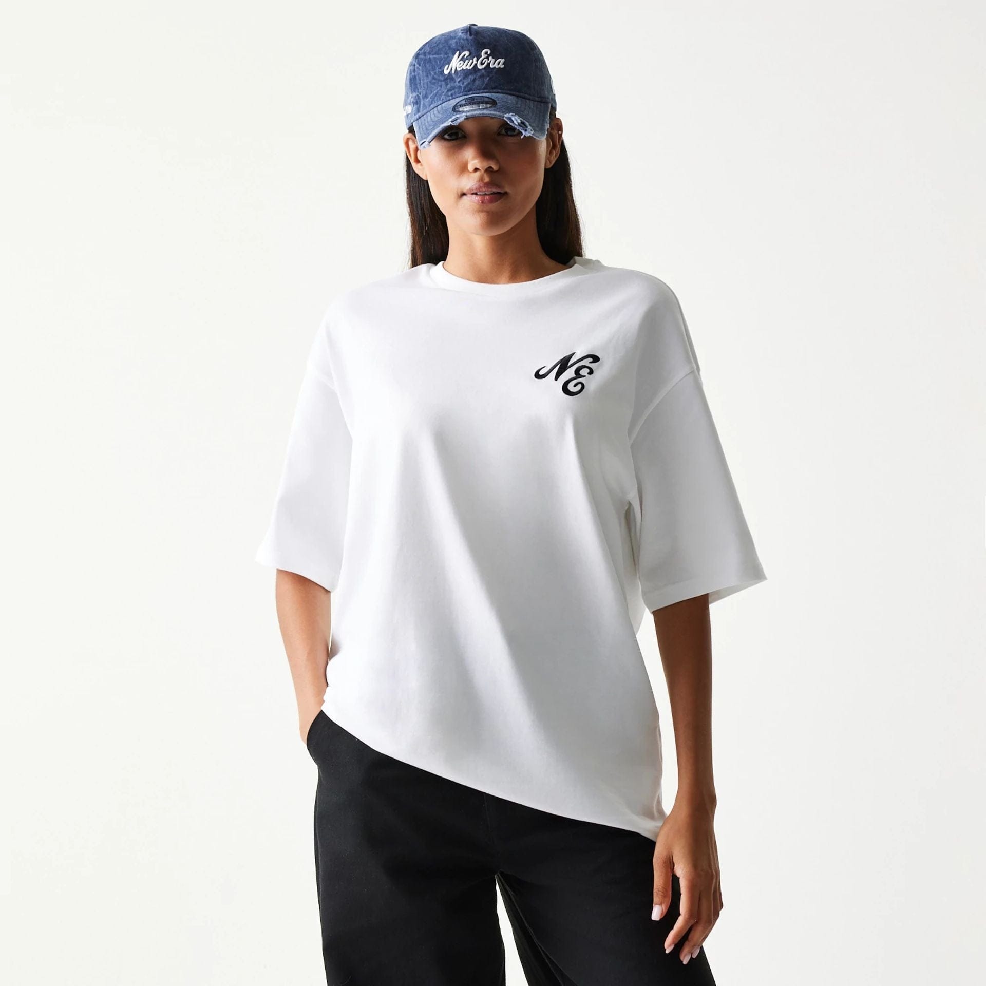 The model is wearing this New Era Floral Graphic Oversized T-Shirt in white. 4