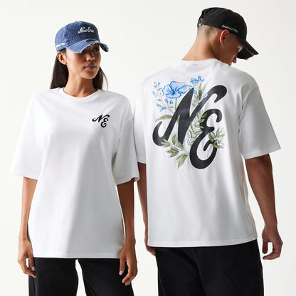 New Era Floral Graphic White Oversized T-Shirt, front and back view on models wearing caps, showing a black embroidered NE logo on the chest and a large NE design with floral graphics in blue and green on the upper back.