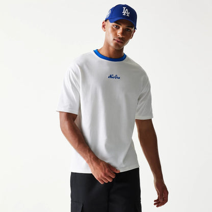 The model is wearing this New Era Script Oversized T-Shirt in white. 3
