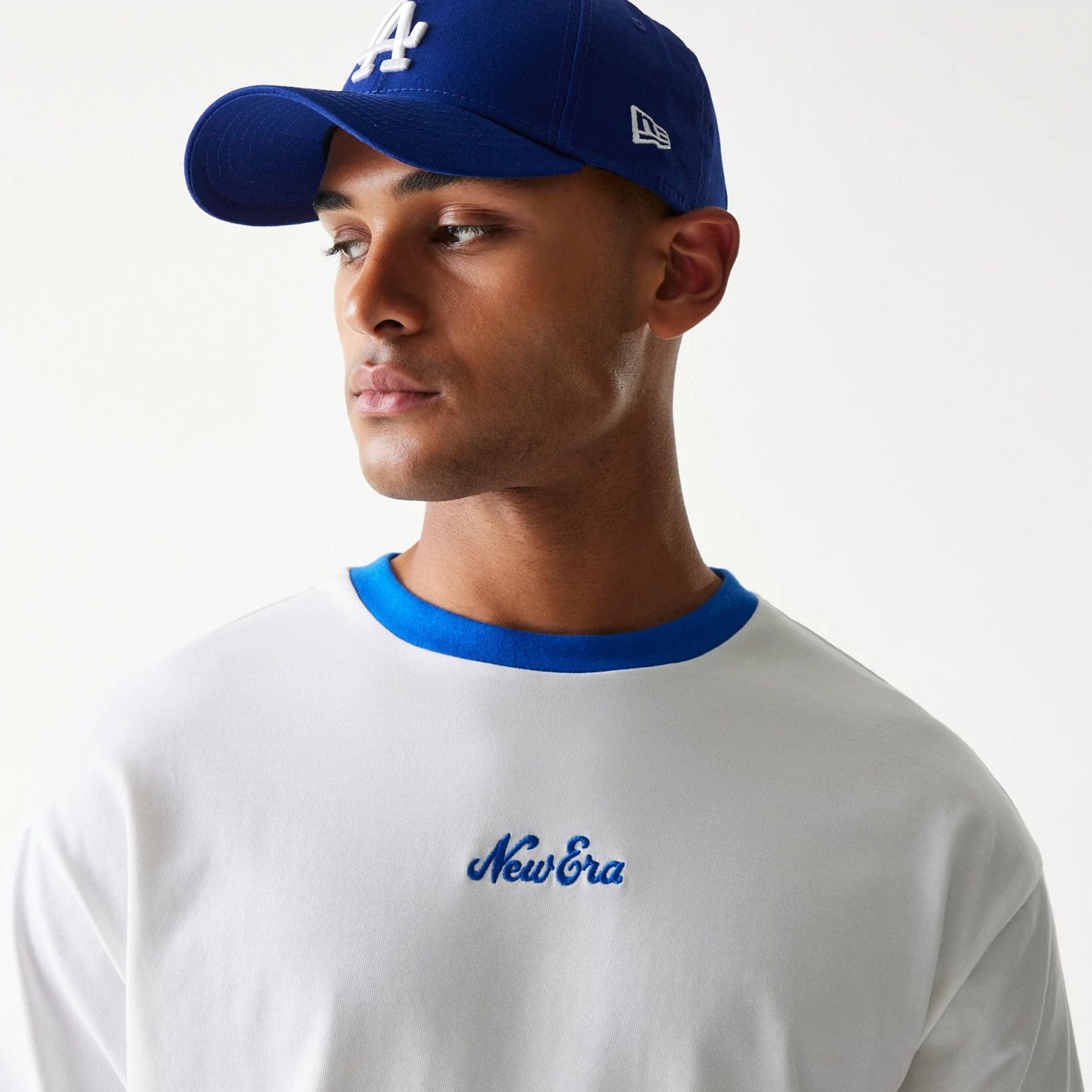 The model is wearing this New Era Script Oversized T-Shirt in white. 5